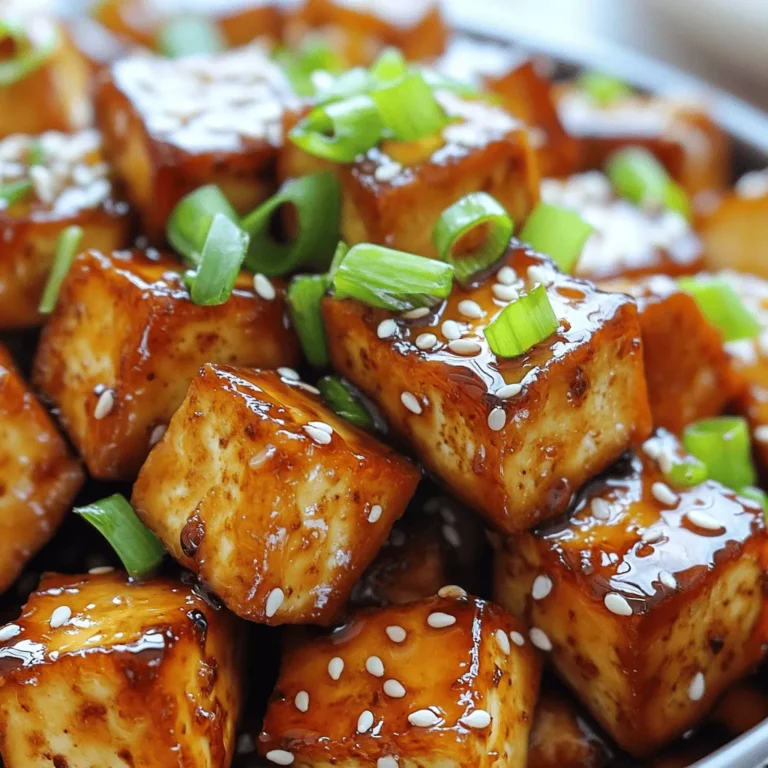 - 14 oz firm tofu, pressed and cubed - 3 tablespoons honey (or agave syrup for vegan option) - 2 tablespoons soy sauce - 1 tablespoon sesame oil - 3 cloves garlic, minced - 1 tablespoon grated fresh ginger - Salt and pepper to taste - 2 green onions, chopped (for garnish) - Sesame seeds (for garnish) When making Air Fryer Honey Garlic Tofu, the right ingredients are key. Firm tofu gives a great texture. Pressing it first helps remove moisture, making it crispier. Honey or agave syrup brings sweetness. Soy sauce adds a savory touch. Sesame oil gives a nutty flavor. Garlic and ginger are flavor powerhouses. They make the dish lively and aromatic. Don't forget salt and pepper to enhance the taste. For garnishes, fresh green onions and sesame seeds add color and crunch. They make the dish look stunning. This simple yet tasty ingredient list ensures you create a dish that is full of flavor and fun! Start by pressing the tofu to remove excess moisture. This step is key for crispiness. Wrap the tofu in a clean kitchen towel and place a heavy object on top. Let it sit for about 15 minutes. After pressing, cut the tofu into bite-sized cubes. This helps the tofu soak up the marinade and cook evenly. In a small bowl, whisk together the honey (or agave syrup for a vegan option), soy sauce, sesame oil, minced garlic, and grated ginger. This mixture creates a sweet and savory flavor that pairs perfectly with the tofu. Once mixed, pour the marinade over the tofu cubes. Toss gently to coat all the pieces evenly. Allow the tofu to marinate for at least 15 minutes. For more flavor, let it sit longer. Preheat your air fryer to 380°F (193°C). This helps achieve that perfect, crispy texture. Arrange the marinated tofu cubes in a single layer in the air fryer basket. Avoid overcrowding to ensure even cooking. You may need to cook in batches. Air fry the tofu for about 15-18 minutes. Shake the basket halfway through to promote even browning. When done, the tofu should be golden brown and crispy. Once cooked, remove the tofu and let it cool slightly before serving. To get the best texture from your tofu, pressing is key. Pressing removes extra moisture, which helps the tofu crisp up nicely. Wrap your tofu in a clean kitchen towel and place something heavy on top. Let it sit for about 15 minutes. This simple step changes everything. Using cornstarch is another trick for crispiness. After marinating the tofu, sprinkle cornstarch over the cubes. Toss gently to coat each piece. This will give you that perfect crunchy exterior when you air fry it. For great flavor, marinate the tofu for at least 15 minutes. The longer you let it soak, the better it tastes. You can also adjust the marinade based on your taste. Want it sweeter? Add more honey. Prefer a salty kick? Increase the soy sauce. Make it yours! Avoid overcrowding the air fryer basket. If you add too much tofu at once, it won't cook evenly. Cook in batches if needed. Different air fryer models might have slightly different heating patterns. So, keep an eye on your tofu while it cooks. Adjust the temperature if necessary to get that golden brown and crispy finish. {{image_2}} If you want a vegan dish, swap honey for agave syrup. It gives a sweet touch without using honey. This change also keeps the dish plant-based. For a gluten-free option, choose gluten-free soy sauce or tamari. Both give great flavor and keep the dish safe for those avoiding gluten. You can add vegetables to your tofu for extra flavor and nutrition. Bell peppers add a nice crunch and color. Broccoli offers a great texture and pairs well with the garlic. Snap peas are also a fun choice to mix in. Just toss them in with the tofu before air frying. They will cook together, making a tasty and colorful dish. Want to switch things up? You can try different sauces. Teriyaki sauce brings a sweet and savory taste. Spicy chili sauce adds heat and a kick. Just replace the honey or agave syrup with your chosen sauce in the marinade. This helps create new flavors and keeps the dish exciting. To store your cooked honey garlic tofu, place it in an airtight container. Make sure to let it cool to room temperature before sealing. This helps keep it fresh. Store the tofu in the fridge for up to three days. If you need it to last longer, consider freezing. When it’s time to enjoy leftovers, I recommend using the air fryer again. Preheat your air fryer to 350°F (175°C). Place the tofu in the basket in a single layer. Air fry for about 5-7 minutes until it’s hot and crispy. If you don’t have an air fryer, you can use a skillet. Heat a little oil in the pan and cook the tofu on medium heat. This method helps keep the tofu crunchy. You can freeze marinated tofu, but it will change the texture. After marinating, place the tofu in a freezer-safe bag. Remove as much air as possible. Store it in the freezer for up to three months. To use frozen tofu, thaw it in the fridge overnight. Then, reheat it according to the tips above. This way, you can enjoy your tasty honey garlic tofu later! Cooking honey garlic tofu in an air fryer takes about 15 to 18 minutes. First, preheat the air fryer to 380°F (193°C). Next, place the marinated tofu cubes in a single layer in the basket. Cook until the tofu turns golden brown and crispy. Remember to shake the basket halfway through cooking to ensure even crispiness. Yes, you can make this recipe without an air fryer. One option is to bake the tofu in the oven. Preheat your oven to 400°F (204°C) and spread the marinated tofu on a baking sheet. Bake for about 25 to 30 minutes, flipping halfway. Another option is to pan-fry the tofu in a skillet over medium heat. Cook for about 5 to 7 minutes on each side until crispy. To add more flavor to your tofu, try these tips: - Use fresh herbs like cilantro or basil for a burst of freshness. - Add a splash of lime or lemon juice for acidity. - Experiment with spices like paprika, cumin, or chili powder for heat. - Marinate the tofu longer for deeper flavors, even up to an hour. - Drizzle with extra honey or soy sauce just before serving for added richness. This blog post guided you through making delicious honey garlic tofu in an air fryer. We covered the main ingredients, cooking steps, tips for the perfect texture, and ways to customize your dish. Remember, pressing your tofu well and marinating it add great flavor. Whether you go vegan or opt for different sauces, this recipe adapts easily. Enjoy your tasty and healthy meal! You’ll impress everyone with your cooking skills.