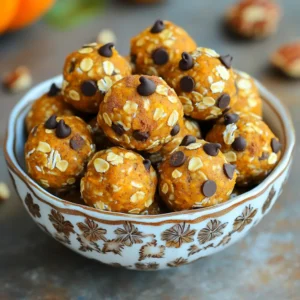 To make No Bake Pumpkin Spice Energy Balls, you need simple and healthy ingredients. Here’s what you’ll need: - 1 cup rolled oats - 1/2 cup almond butter - 1/2 cup canned pumpkin puree - 1/4 cup honey or maple syrup - 1 teaspoon vanilla extract - 1 teaspoon pumpkin pie spice - 1/4 teaspoon salt - Optional add-ins: - 1/4 cup mini chocolate chips - 1/4 cup chopped walnuts or pecans Each ingredient plays a key role in flavor and texture. The oats give a hearty base, while almond butter adds creaminess. Pumpkin puree brings moisture and a lovely fall flavor. Honey or maple syrup sweetens the mix nicely. Vanilla extract adds depth, and pumpkin pie spice gives that warm, cozy aroma we love. A pinch of salt balances the sweetness. If you want to make them even more fun, add chocolate chips or nuts. The chocolate adds a nice surprise, and the nuts give a delightful crunch. These energy balls are not just tasty; they are also packed with nutrients. Enjoy making this easy snack that’s perfect for any time of the day! First, grab a large mixing bowl. Add 1 cup of rolled oats. Next, scoop in 1/2 cup of almond butter. Then, add 1/2 cup of canned pumpkin puree. Pour in 1/4 cup of honey or maple syrup. Finally, add 1 teaspoon of vanilla extract. Mix all these ingredients well. You want a sticky dough to form. Now, sprinkle in 1 teaspoon of pumpkin pie spice and 1/4 teaspoon of salt. Stir until everything blends well. If you want some extra flavor, fold in 1/4 cup of mini chocolate chips and 1/4 cup of chopped nuts. Use walnuts or pecans for a nice crunch. Take about 1 tablespoon of the mixture. Roll it into a ball using your hands. Repeat this step until you shape all the mixture into balls. Place the energy balls on a baking sheet lined with parchment paper. Refrigerate them for at least 30 minutes. This will help them firm up nicely. When they are chilled, store them in an airtight container in the fridge. Enjoy your tasty snack! To get the best texture, use rolled oats. They help create a chewy bite. You want your mixture sticky but not too wet. If it's too dry, add a bit more almond butter or syrup. If it’s too wet, mix in some oats until it feels just right. You can switch things up to match your taste. Try using different nut butters like peanut or cashew. You can also add spices. Cinnamon or nutmeg can add a warm touch. For a fun twist, add dried fruit like cranberries or raisins. This gives a sweet and chewy bite. Presentation matters! Arrange the energy balls in a nice bowl. Sprinkle them with extra pumpkin pie spice for a festive look. You can also use colorful cupcake liners to make them pop. These energy balls are perfect for snacks at home or to share at parties. {{image_2}} You can easily change your energy balls by adding different ingredients. Try using sunflower seed butter instead of almond butter for a nut-free option. You can also swap the mini chocolate chips for dried fruit like cranberries or raisins. Seeds like chia or flax can add crunch and boost nutrition. Pumpkin spice is perfect for fall, but you can mix it up! In winter, add peppermint extract for a fresh twist. For spring, use lemon zest to brighten the flavor. Summer calls for coconut flakes for a tropical vibe. Each season brings new chances to enjoy these bites. These energy balls can fit many diets. To make them gluten-free, use certified gluten-free oats. If you need them nut-free, opt for sun butter instead of almond butter. Vegan eaters can replace honey with maple syrup. This way, everyone can enjoy these tasty snacks! You should store your No Bake Pumpkin Spice Energy Balls in an airtight container. This keeps them fresh and tasty. A glass jar works great if you have one. You can also use a plastic container with a tight lid. Placing parchment paper between layers helps prevent sticking. These energy balls stay fresh in the fridge for up to a week. After that, they may lose flavor and texture. Check for any signs of spoilage, like an off smell or mold. If they look good and smell right, they’re likely fine to eat. For longer storage, you can freeze the energy balls. Place them in a single layer on a baking sheet first. Freeze them for about an hour. After that, pop them into a freezer-safe bag or container. They can last for up to three months in the freezer. Just thaw them in the fridge before enjoying! Yes, you can use other nut butters. Peanut butter works well. Sunflower seed butter is a great option if you need nut-free. Each butter adds a unique taste. Just pick what you like best! These energy balls last about one week in the fridge. Store them in an airtight container. If you want them to last longer, you can freeze them. They will keep well for up to three months in the freezer. You can make these without pumpkin puree. Try using applesauce for a fruity twist. You can also use mashed bananas for a different flavor. Each option will change the taste and texture a bit. This blog post shows how to make tasty, healthy energy balls using simple ingredients. We discussed combining oats, almond butter, and pumpkin puree for a nutritious snack. You can customize these balls with spices, flavors, and add-ins like chocolate chips or nuts. We also covered storage tips to keep them fresh. In the end, these energy balls are fun to make and great to eat anytime. Enjoy creating your snacks!